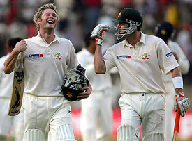 Australia�s Michael Clarke and team-mate Damien Martyn walk back to the pavillion at the close of the third day�s play of the first Test between India and Australia