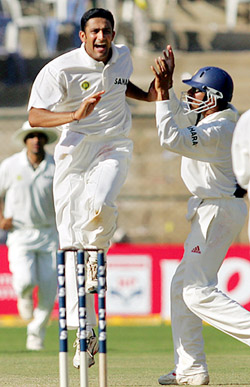 Anil Kumble celebrates with Akash Chopra after taking the wicket of Simon Katich