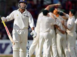 Yuvraj Singh walks back to the pavilion as Australian players celebrate his dismissal on the fourth day of the first Test 