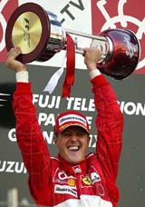 Ferrari driver Michael Schumacher of Germany holds up the trophy after winning the Japanese F-1 Grand Prix 