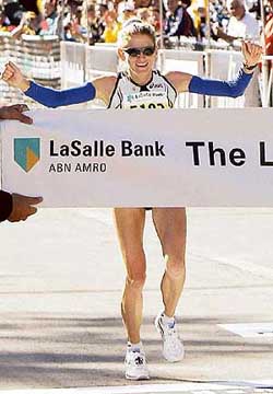 Constantina Tomescu-Dita, of Romania, celebrates as she crosses the finish line to win the 27th Chicago Marathon