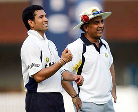 India's star batsman Sachin Tendulkar and team consultant and former player Sunil Gavaskar look on during a training