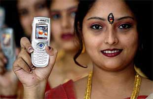 A model poses with the Bengali language Samsung E 800 mobile phone at its launch in Kolkata