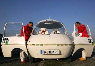 Participants board their electric-powered Courr�ges La Bulle car at the start of the Challenge Bibendum Rally, a clean vehicle event, in Shanghai 
