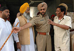 A Congress supporter argues with Mr S.S. Dhindsa, MP and former Akali minister, as a police officer intervenes at Hindu Kanya College, Kapurthala, on Wednesday.