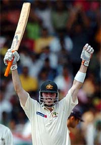 Australia's Damien Martyn raises his bat after completing his century