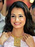 Bollywood actress Diya Mirza wears a gold necklace at the start of a weeklong gold extravaganza in New Delhi on Monday. 