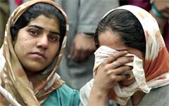 Women wail following the electrocution of two children at a school near Srinagar on Monday.