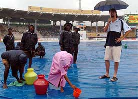 Australia�s Jason Gillespie watches ground staff at work on the fifth day of the second Test at the MA Chidambaram Stadium in Chennai