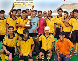 Members of the hockey team of Guru Harkrishan Public School, New Delhi, pose with the trophy after winning the All-India Sardar Balwant Singh Memorial Hockey Tournament