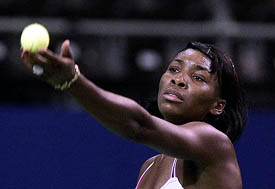 Venus Williams of the US serves during her first round match