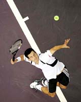 Britain's tennis player Tim Henman serves to Albert Costa of Spain