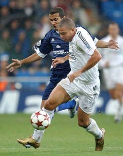 Real Madrid's Brazilian striker Ronaldo steers the ball away