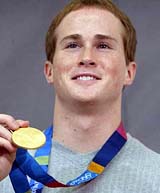 Gymnast Paul Hamm holds his 2004 Olympic gold medal during a news conference in New York