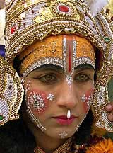 A boy dressed as Lord Ram taking part in a religious procession