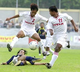 Manipur players Manitombi Singh and Tiken Singh tackle the ball 