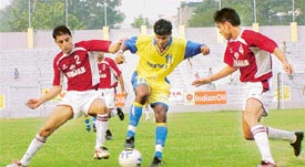 Punjab players try to wrest the ball from a Goan player during the quarterfinal match of Santosh Trophy