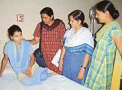 Activists of women’s organisations break the news of validation of her marriage by Asanda villagers to Sonia at the PGIMS, Rohtak, on Thursday.