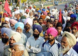 Members of the Dihati Mazdoor Sabha, Punjab, block traffic at the BMC Chowk in Jalandhar on Friday. 