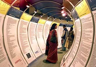 Visitors look at information technology posters during the seventh edition of the IT industry exposition in Bangalore