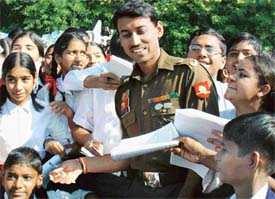 Olympic medal winner Maj R S Rathore is besieged by students during his visit to Chandimandir Military Station