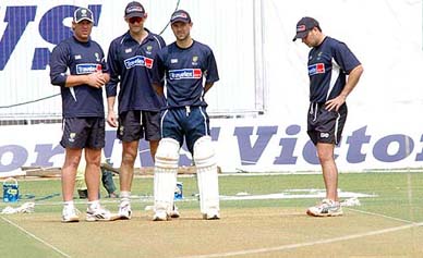 Australian cricketers Shane Warne, Adam Gilchrist and Ricky Ponting examine the pitch at the Wankhede Stadium 