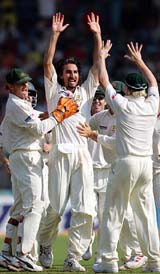 Jason Gillespie celebrates with teammates after dismissing Mohammad Kaif
