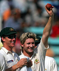 Australia's Michael Clarke shows the ball with which he claimed six wickets 