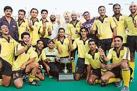 Winner team of Punjab & Sind Bank with trophy in Jubilant mood after winning 21st Indian Oil Surjit Hockey Tournament 