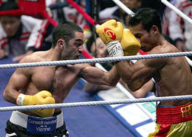 France's champion Mahyar Monshipour lands a left jab against challenger Thailand's Yoddamrong Sithyodthong