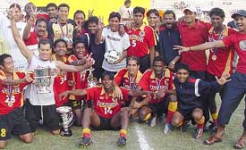 Players and coach of East Bangal team with the trophy they won after defeating Mohun Bagan 2-1 in Durand Cup final in New Delhi on Wednesday. 