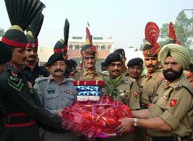 BSF officials present sweets to their counterparts in Pakistan at the Wagah checkpost on the occasion of Divali. 