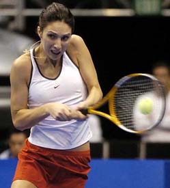 Anastasia Myskina of Russia returns a shot during her 7-6, 6-4 victory over Lindsay Davenport in the WTA Championship 