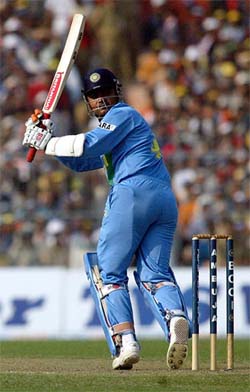 Virender Sehwag sends the ball to the fence during his knock of 53