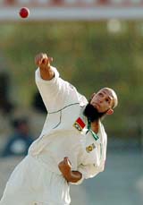 South African cricketer of Indian origin, Hashim Amla, bowls on the second day of a three-day match against Board President's XI