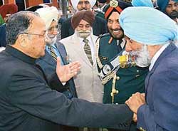 Maj-Gen (retd) Tarlochan Singh (right) clasps Gen S.F. Rodrigues’ hand as old buddies meet at the swearing in of the latter as Governor of Punjab in Chandigarh on Tuesday.