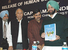 Punjab Chief Minister Amarinder Singh (right) releases the Human Development Report, 2004, in Chandigarh, on Tuesday. Mr S.S. Johal, Mr Surinder Singh and Mr Sandeep Dixit are also in the picture.