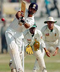 Hemang Badani of Board President�s XI hits a shot as South African wicketkeeper Thami Tsolekile and Andrew Hall look on
