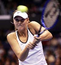 Russia's Maria Sharapova hits a backhand return against Serena Williams in the final match of the WTA Tour Championships in Los Angeles on Monday