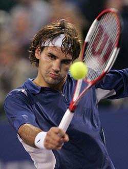 Roger Federer of Switzerland returns a shot to Gaston Gaudio of Argentina during the second set of their match at the Tennis Masters' Cup in Houston