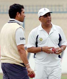 Former Indian captain Sunil Gavaskar speaks to Sachin Tendulkar during a practice session in Kanpur on Thursday