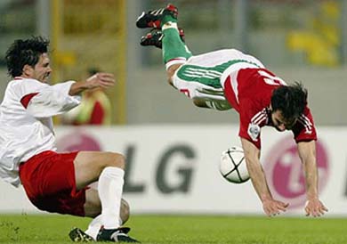 Hungary's Tamas Hajnal flies through the air after being tripped by Malta's Brian Said during the Group 8 World Cup qualifier match at Ta Qali National stadium outside Valletta on Thursday