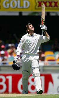 New Zealand's Jacob Oram raises his bat after reaching his century on day two of the first Test in Brisbane on Friday
