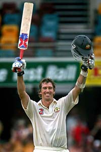 Australia�s Glenn McGrath raises his bat and helmet after scoring his first Test half century on the third day of the first Test against New Zealand in Brisbane 
