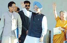 Prime Minister Manmohan Singh and his wife wave to the crowd at the inaugural function of the Capital Complex at Dispur in Guwahati on Sunday. Also seen in the picture is Assam Chief Minister Tarun Gogoi.