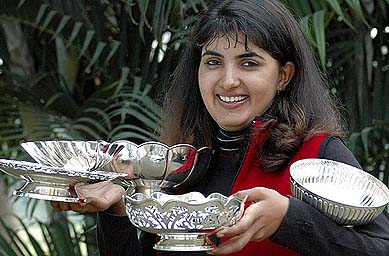 Irina Brar balances her trophies at the Chandigarh Golf Club on Tuesday
