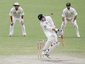 New Zealand batsman Jacob Oram ducks away from a bouncer as Australian fieldsman Ricky Ponting looks on on the fourth day of the second Test in Adelaide on Monday