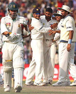 Harbhajan Singh being congratulated by his team-mates after dismissing Andrew Hall of South Africa