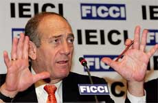 Israel�s Deputy Prime Minister Ehud Olmert gestures during a business seminar in New Delhi on Wednesday. 
