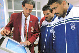 A student of YPS shows results to Pakistani players on the Indo-Pak Punjab Games official website at the polo ground in Patiala on Wednesday. 